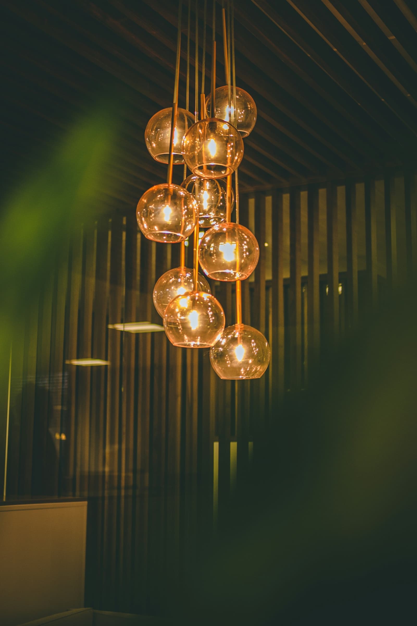 Warm amber pendant lights in a considered interior